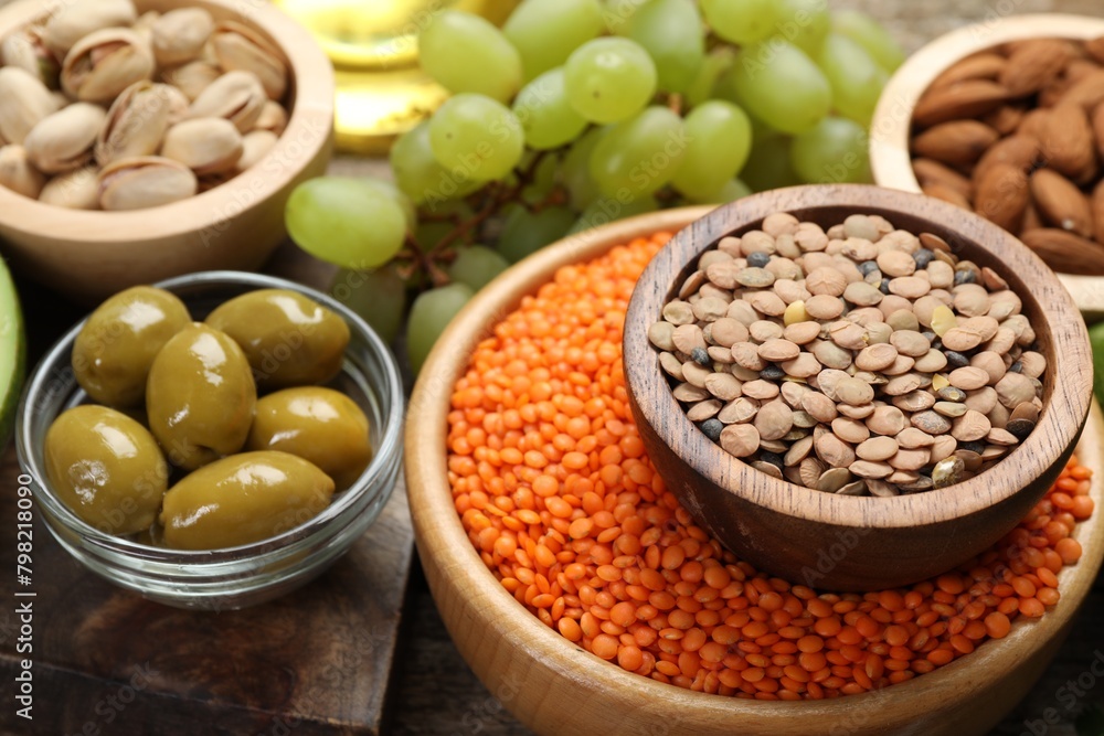 Different products high in natural fats on wooden table, closeup Different products high in natural fats on wooden table, closeup