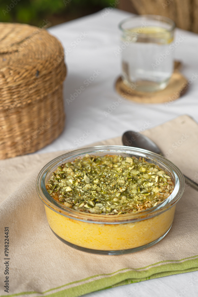 Pumpkin casserole with seeds on a table with a tablecloth near the house Pumpkin casserole with seeds on a table with a tablecloth near the house