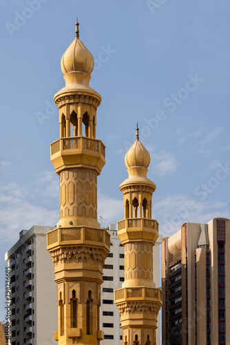 Minarets of the mosque against modern buildings in Abu Dhabi, UAE