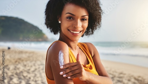 Woman smearing Sun screen on her body - Protection against UV Light - Female on the Beach in the Summer photo