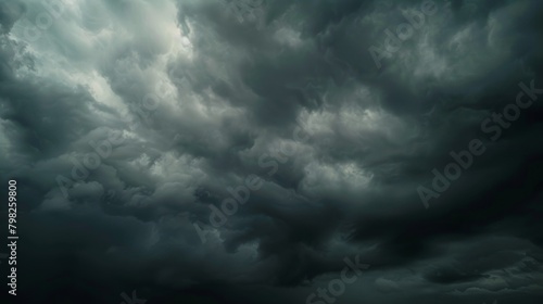 A dark sky filled with ominous clouds, creating an atmospheric and moody scene. The clouds are thick and heavy, hinting at potential rain or a storm approaching.