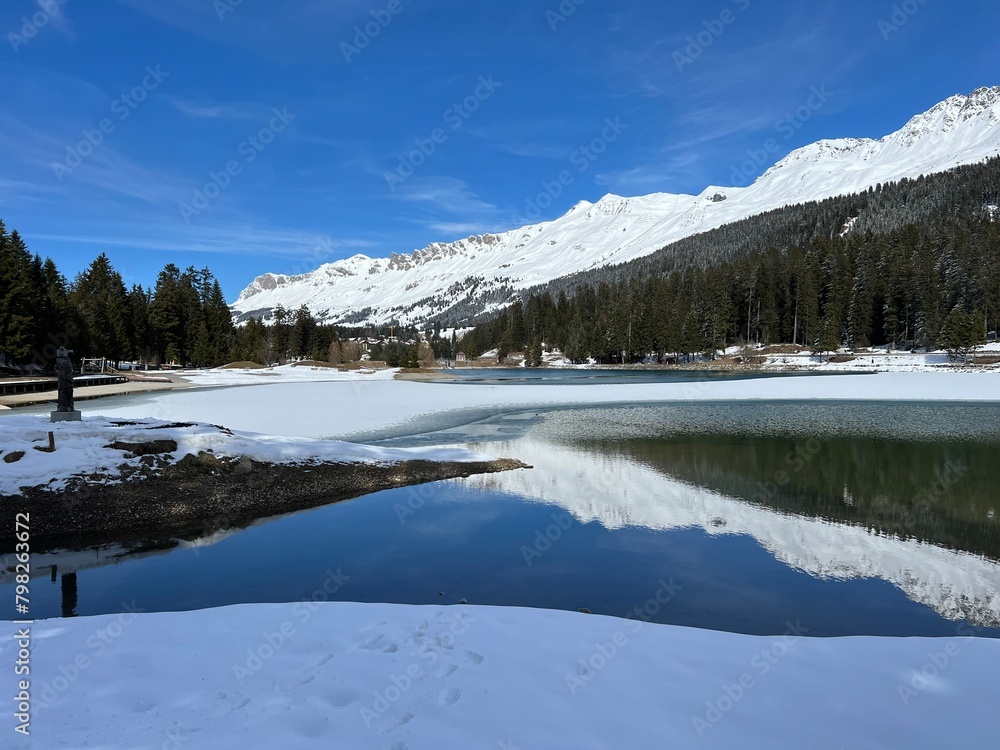 A typical winter idyll on the frozen and snow-covered alpine lake Heidsee (Igl Lai) in the Swiss winter resorts of Valbella and Lenzerheide - Canton of Grisons, Switzerland (Schweiz) A typical winter idyll on the frozen and snow-covered alpine lake Heidsee (Igl Lai) in the Swiss winter resorts of Valbella and Lenzerheide - Canton of Grisons, Switzerland (Schweiz)
