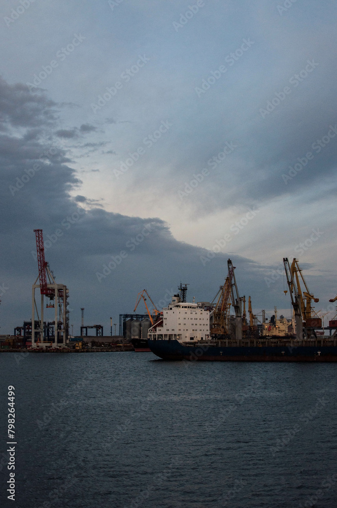 Logistics and transportation of International Container ship in the ocean at twilight sky