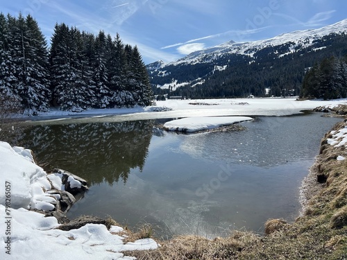 A typical winter idyll on the frozen and snow-covered alpine lake Heidsee (Igl Lai) in the Swiss winter resorts of Valbella and Lenzerheide - Canton of Grisons, Switzerland (Schweiz) photo