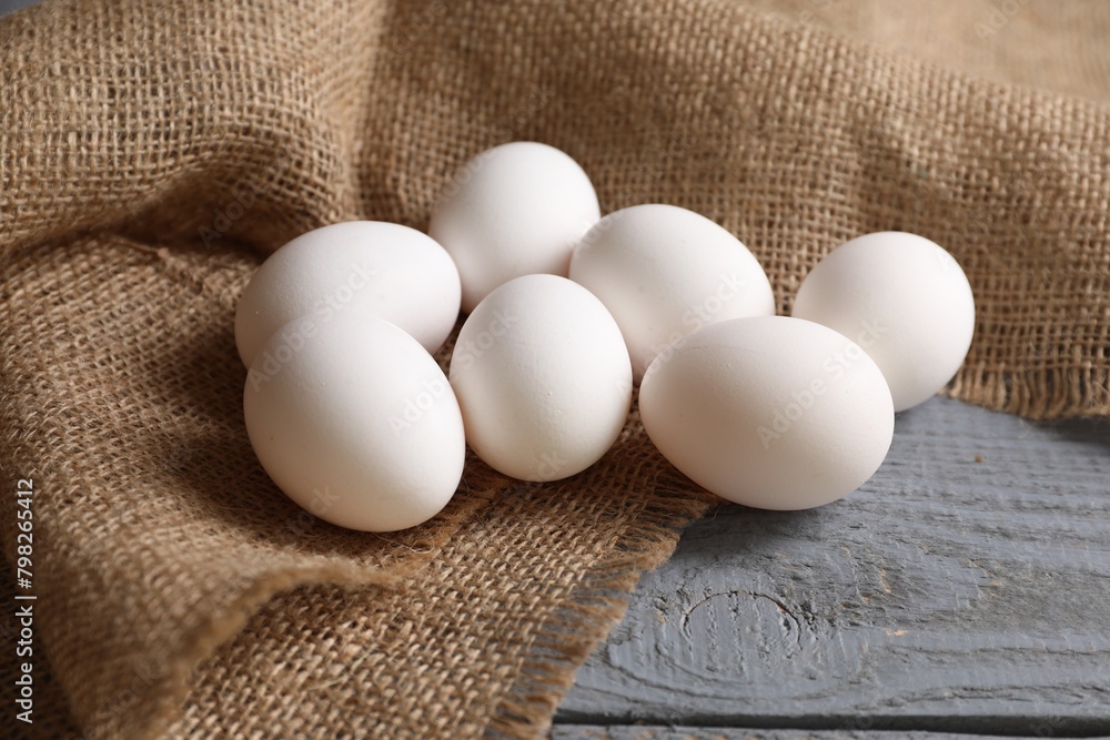 Fresh chicken eggs on grey wooden table, closeup Fresh chicken eggs on grey wooden table, closeup