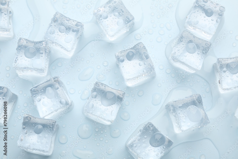 Crystal clear ice cubes on light blue background, flat lay Crystal clear ice cubes on light blue background, flat lay