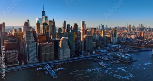Skyscrapers standing side by side at the waterfront of the East River. New York scenery from aerial perspective.