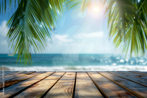 Abstract blurred background of a wooden table top with palm leaves and a blue sea in summer