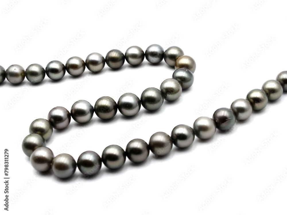 Expensive and luxurious Tahiti black pearls in a stylish necklace on white background, ready to be made into earrings, pendants, bracelets or a choker and sold in jewelry store. Expensive and luxurious Tahiti black pearls in a stylish necklace on white background, ready to be made into earrings, pendants, bracelets or a choker and sold in jewelry store.