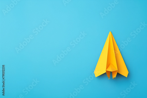 Yellow paper plane, copy space © Syeda