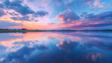 Vibrant twilight sky over a tranquil lake, reflection of pastel colors on the water, gentle ripples on the water surface