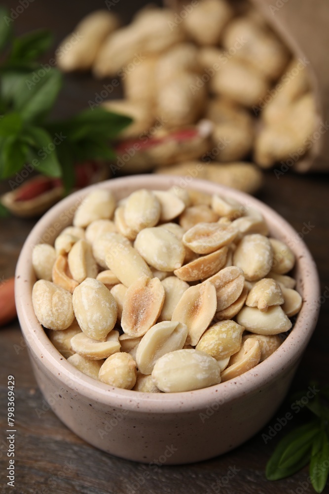 Fresh peeled peanuts in bowl on wooden table, closeup Fresh peeled peanuts in bowl on wooden table, closeup