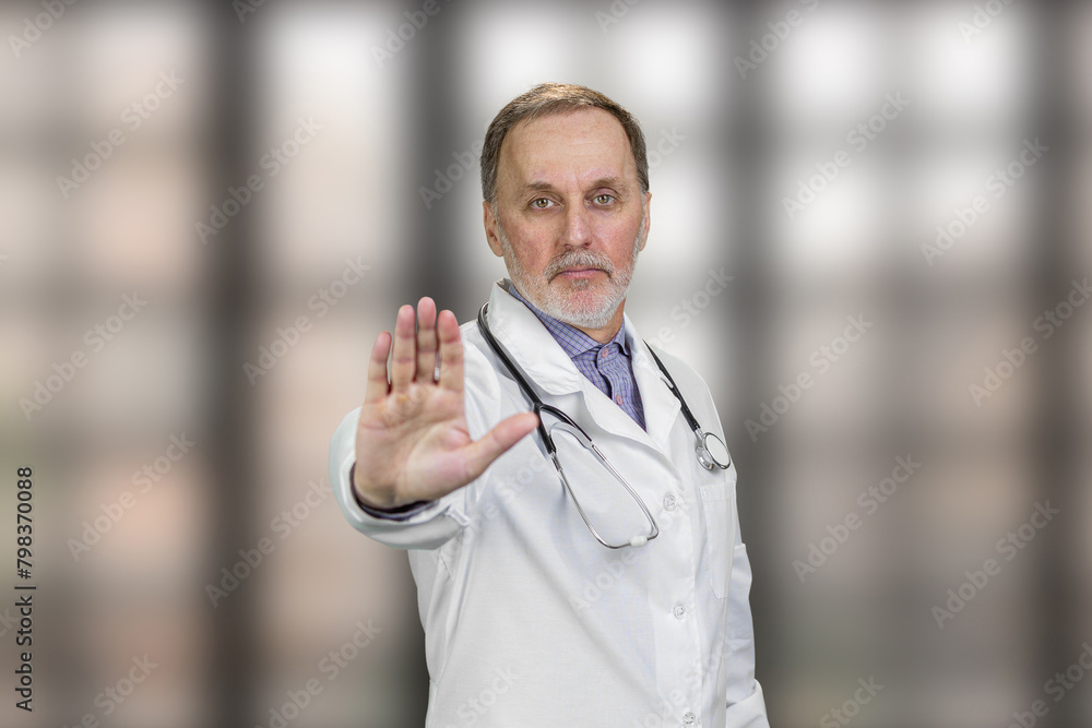 Serious physician doctor shows stop gesture sign. Elder male doctor ...