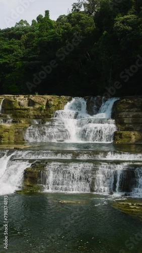 Flying over the widest multi-tiered waterfall in the Philippines. Tinuy-an Falls in Bislig, Surigao del Sur. Vertical view. photo