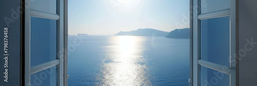 Window overlooking the ocean with the sun shining on the water