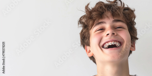 A boy with braces on a white background