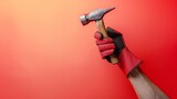 A Hand in a Protective Glove Wielding a Hammer, Poised Against a Red Background, Symbolic of Labor Day and Skilled Craftsmanship