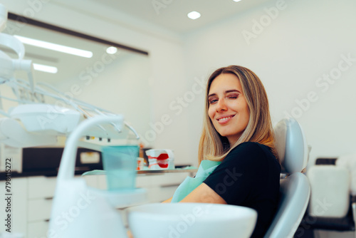 Happy Patient Smiling and Winking in Dentist Office. Cheerful woman having a great experience at the dental office 