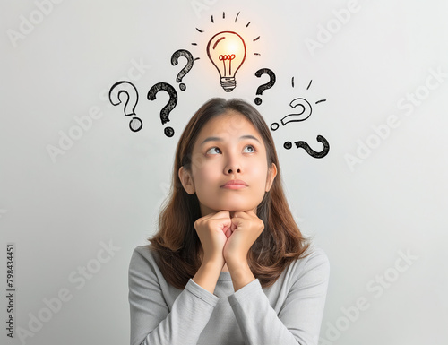 A woman looking thoughtful with illustrated question marks and a lightbulb symbol overhead, representing a concept of brainstorming or having an idea, against a light grey background. Generative AI