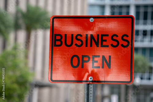 business open sign in orance in a downtown city photo