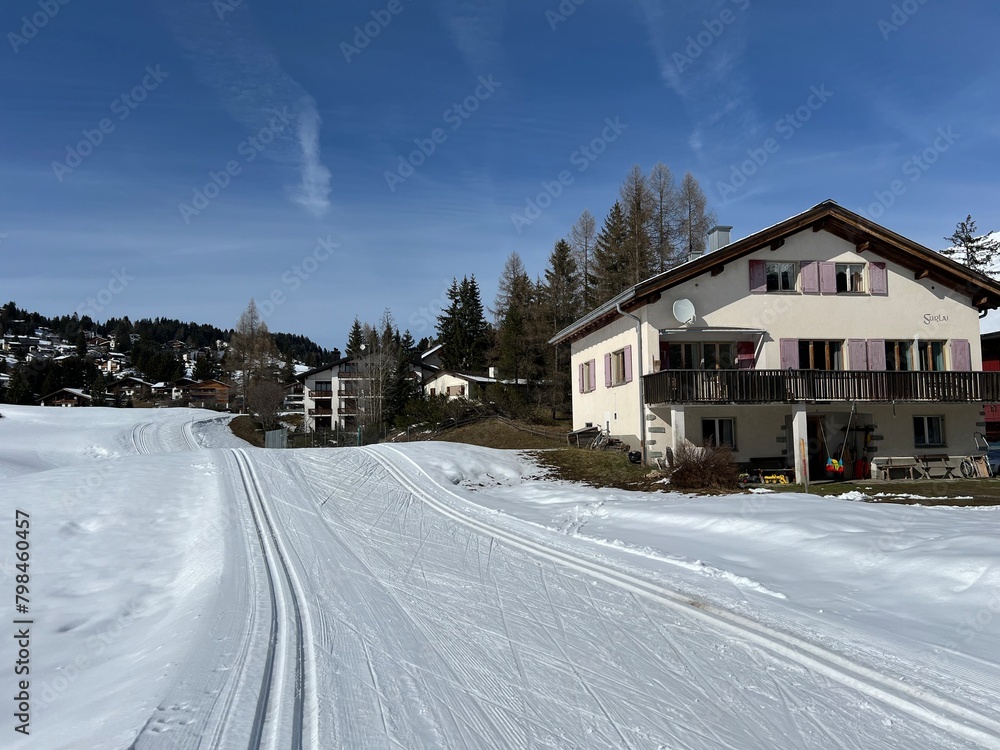 A winter sport cross-country ski trail around a frozen alpine Heidsee lake (Igl Lai lake) in the Swiss winter resorts of Valbella and Lenzerheide - Canton of Grisons, Switzerland (Schweiz)