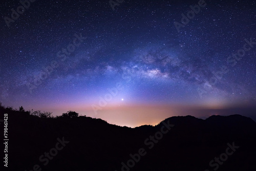 landscape silhouette tree on high moutain before sunrise with milky way galaxy photo