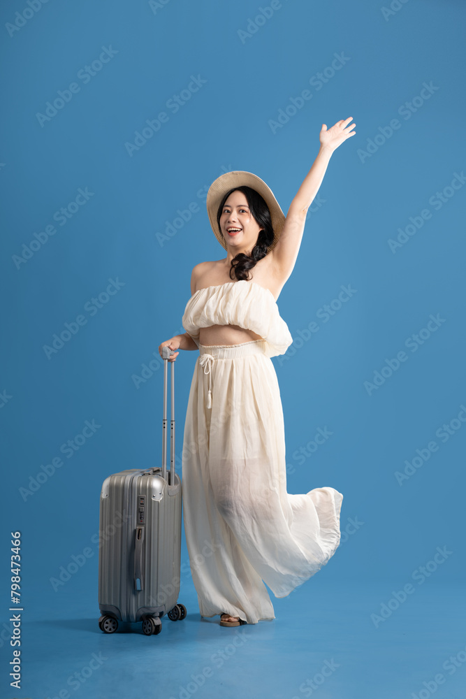 Portrait of asian girl posing on blue background, traveling in summer Portrait of asian girl posing on blue background, traveling in summer