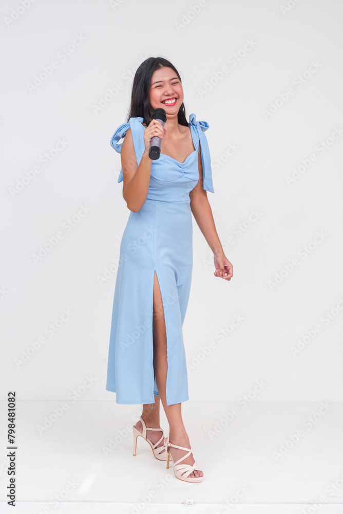 Full body photo of a smiling young Asian woman acting as an emcee ...
