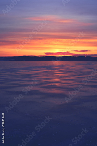 Sunrise above a frozen Lake Mjosa covered with ice  seen from Panengen in Totenvika a winter morning in March.