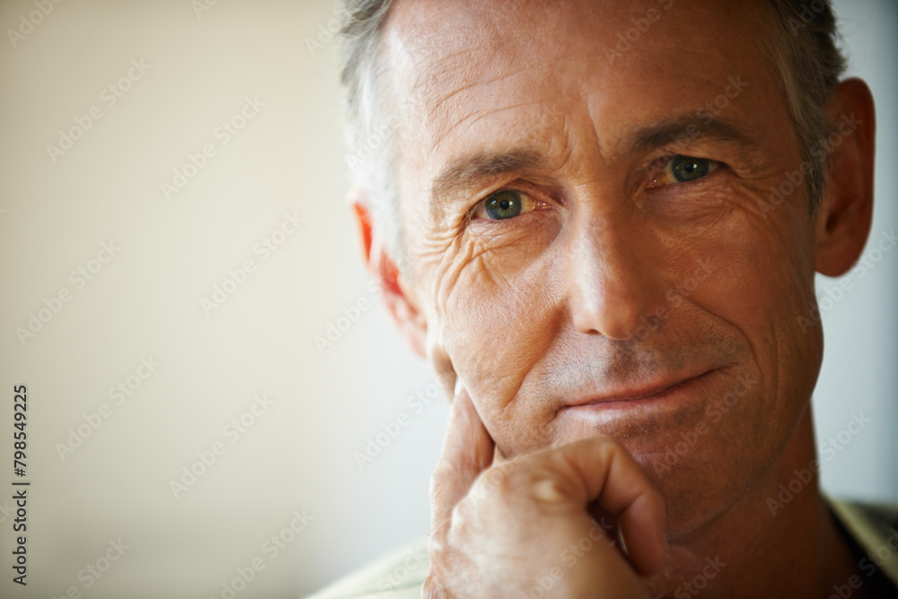 Fototapeta premium Headshot, senior man and portrait thinking about retirement at home, apartment and living room with mockup space. Hand, idea and mature male person in house to relax in lounge for elderly care
