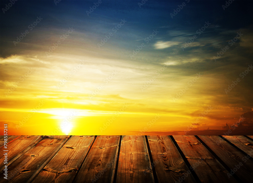Wooden table on sky background and sunset light Wooden table on sky background and sunset light