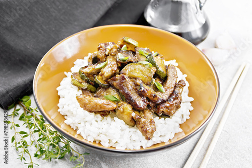 Stir-fried of chicken with zucchini in plate on granite countertop