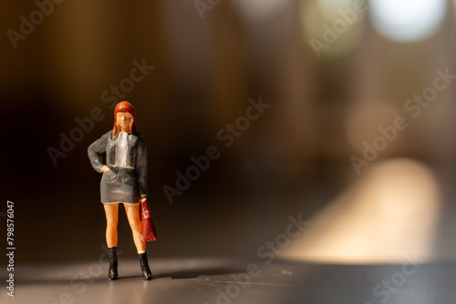 Miniature people ,  A businesswoman standing alone with a suitcase