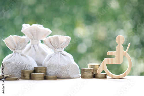 Man on wheelchair and coin money on natural green background,Save money for prepare in future and handicapped person concept