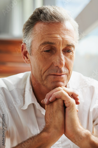 Senior man, hands and thinking at home for decision, choice or idea on retirement and pension. Mature person, thought or wonder in house contemplating for memories, reflection or moment alone