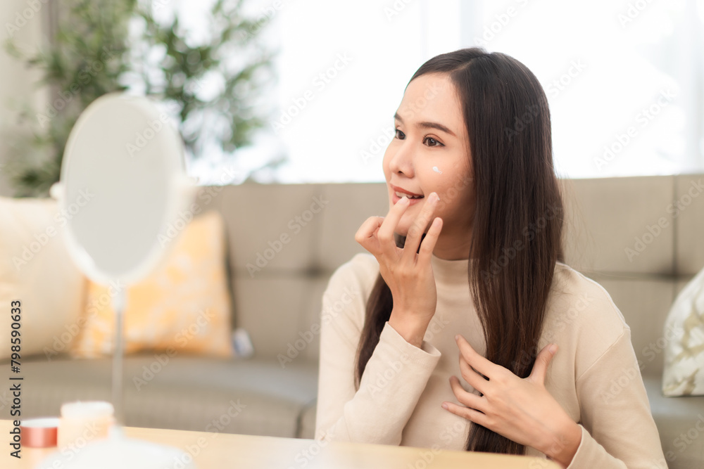 Young Asian woman doing skin care spending time at home . Young Asian woman doing skin care spending time at home .