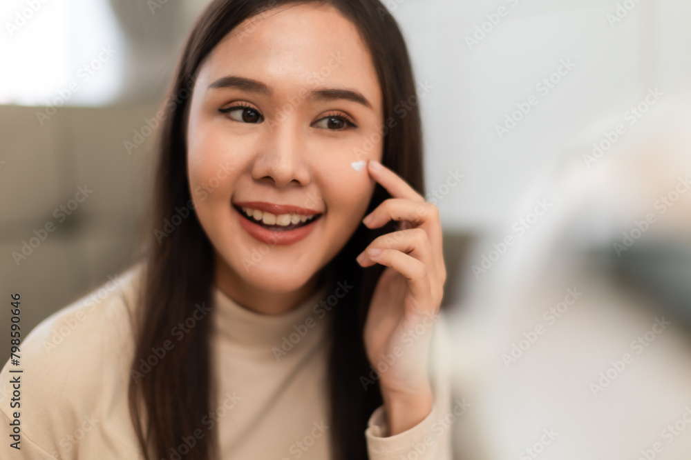 Young Asian woman doing skin care spending time at home . Young Asian woman doing skin care spending time at home .