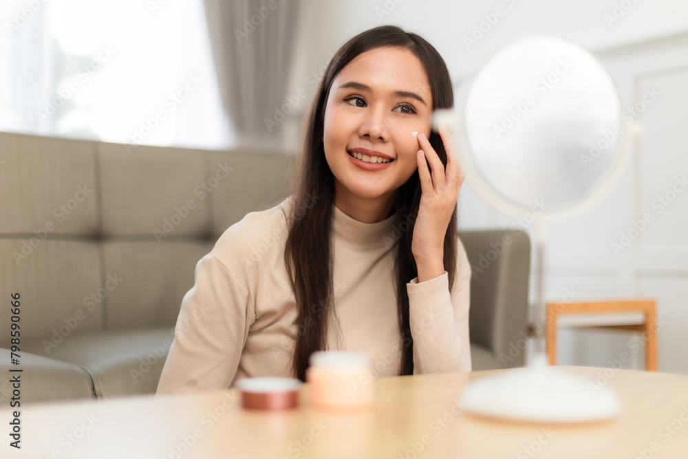 Young Asian woman doing skin care spending time at home . Young Asian woman doing skin care spending time at home .