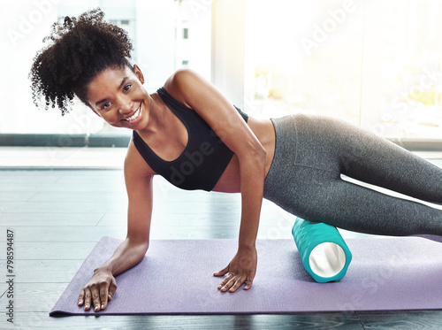 Portrait, smiling and girl on mat, foam roller and training at home, yoga and cool down for wellness, muscle relaxation and health. Fitness, exercise and activity for workout, happy and massage