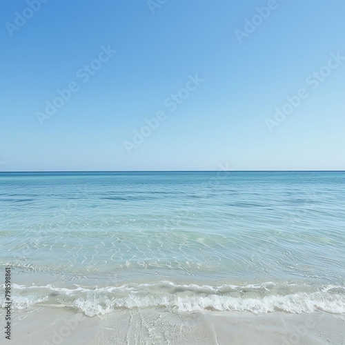 Serene beach scene with calm turquoise waters under a clear sky, ideal for travel and vacation concepts, with ample copy space © Samaphon