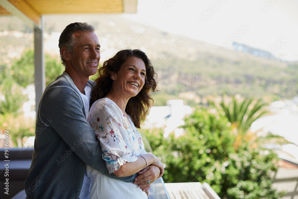 Obraz premium Home, balcony or mature couple hug on anniversary for support, date or love for care, marriage or trust. Smile, view or happy woman bonding with man in retirement, honeymoon break or house to relax