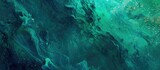 Vibrant gradient burst of fluid waves in celestial hues of emerald and cosmic teal