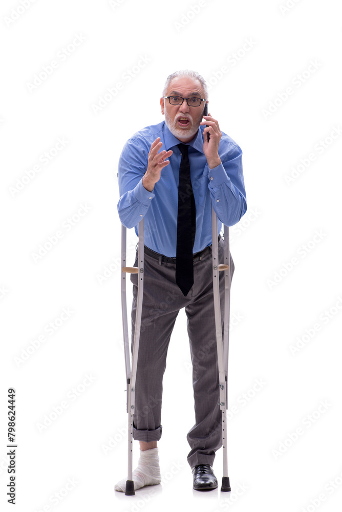 Old businessman with crutches isolated on white Old businessman with crutches isolated on white