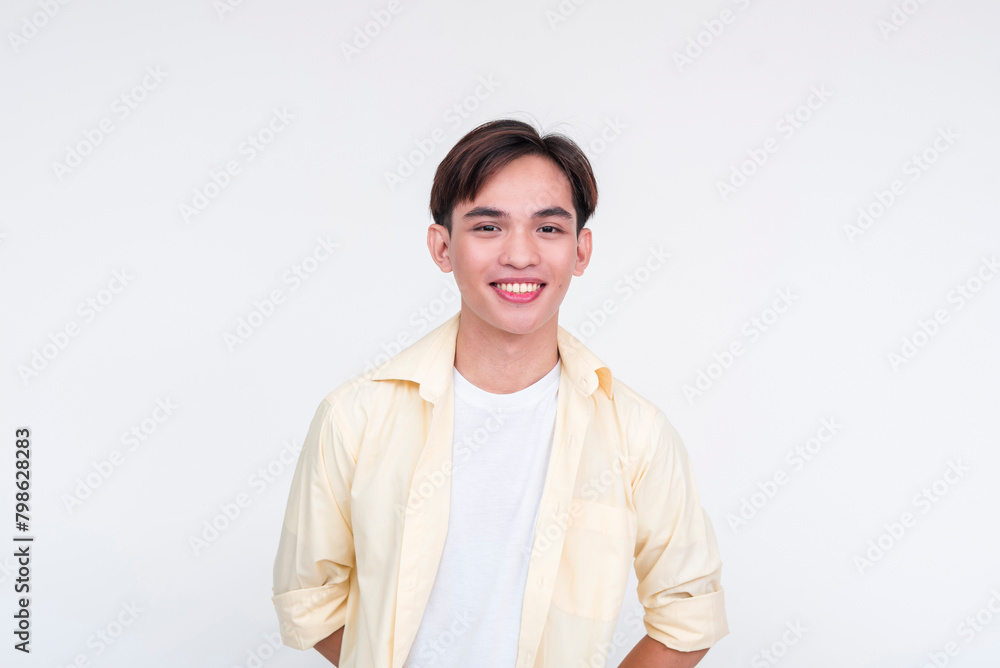 A handsome young asian man in an unbuttoned yellow polo and white shirt. Boy next door vibes. Isolated on a white background. A handsome young asian man in an unbuttoned yellow polo and white shirt. Boy next door vibes. Isolated on a white background.