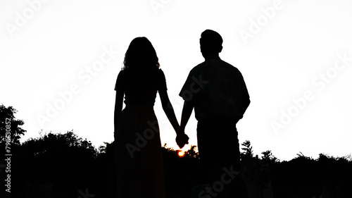 The scene depicts a silhouette of a loving couple.