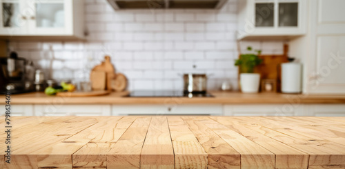 Wood table top on blur kitchen counter with window (room)background.For montage product display or design key visual layout.