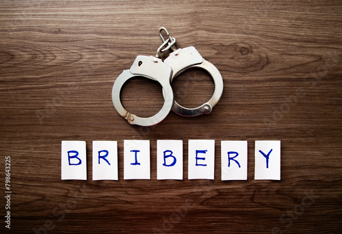 Handcuffs and the word of Bribery.