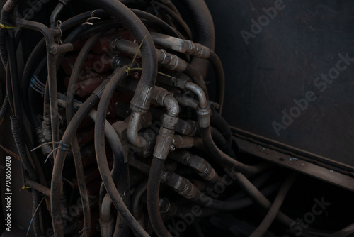 Messy looking hydraulic lines on the back of a crane car  