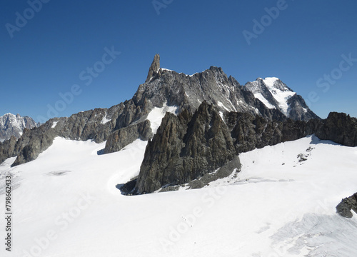 View of the Giant´´´´  s Tooth in the mountainsides of the Mont-Blanc during the summer from the Pointe Helbronner. Alps Mountains. Border between Italy and France.