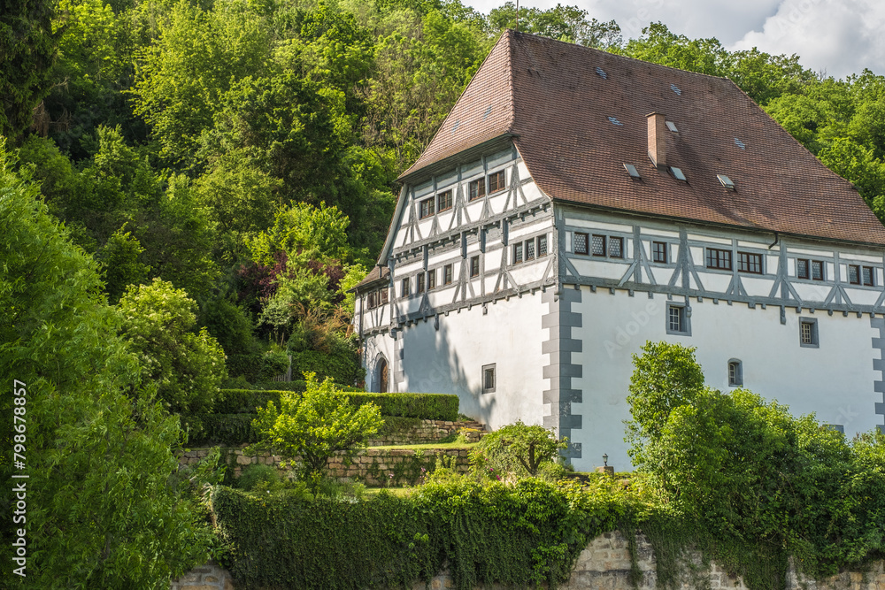 Historisches Fachwerkgebäude Neckarburg mit Walmdach und Butzenscheiben vor Wald in Neckartenzlingen Historisches Fachwerkgebäude Neckarburg mit Walmdach und Butzenscheiben vor Wald in Neckartenzlingen